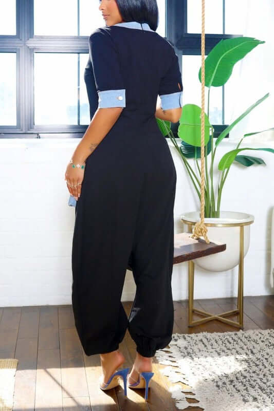 View of the back of a Denim Accent Jumpsuit with oversized pockets and denim accents, showcasing a relaxed fit and drop-crotch silhouette.