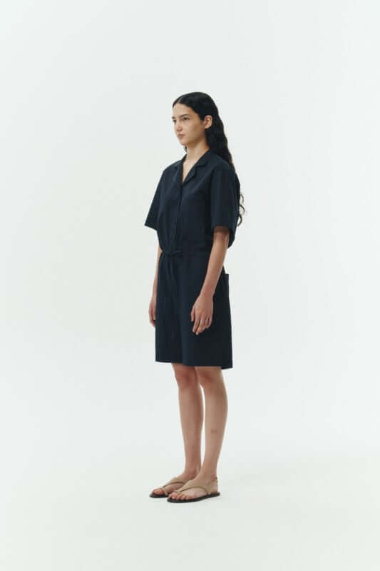 Model wearing the Emma Solid Jumpsuit in navy, featuring a camp collar and a comfortable fit for all-day wear.
