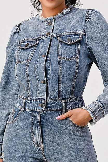 A model wearing a LONG SLEEVE DENIM ROMPER featuring a classic blue wash and cinched waistline.