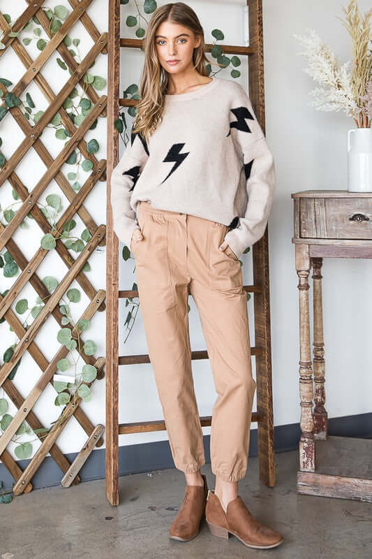BOLT LONG SLEEVE CREW NECK SWEATER worn by model in casual outfit, featuring soft fabric and bolt lighting print.