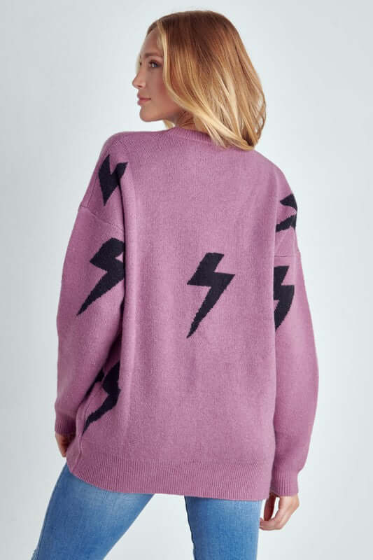 Model showcasing the BOLT LONG SLEEVE CREW NECK SWEATER with black lightning print on a soft fabric.