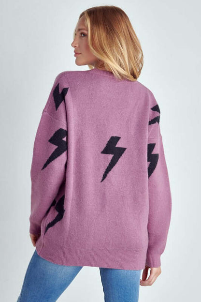 Model showcasing the BOLT LONG SLEEVE CREW NECK SWEATER with black lightning print on a soft fabric.
