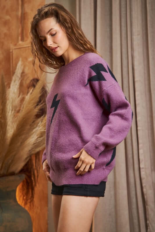 BOLT LONG SLEEVE CREW NECK SWEATER in purple with lightning print, worn by model, showcasing soft fabric and stylish design.