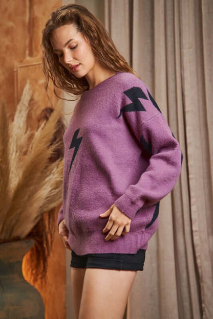 BOLT LONG SLEEVE CREW NECK SWEATER in purple with lightning print, worn by model, showcasing soft fabric and stylish design.