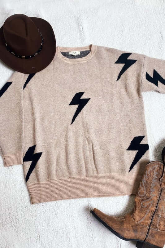 BOLT LONG SLEEVE CREW NECK SWEATER with bolt lightning print, soft fabric, styled with a brown hat and cowboy boots.