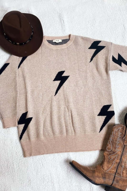 BOLT LONG SLEEVE CREW NECK SWEATER with bolt lightning print, soft fabric, styled with a brown hat and cowboy boots.