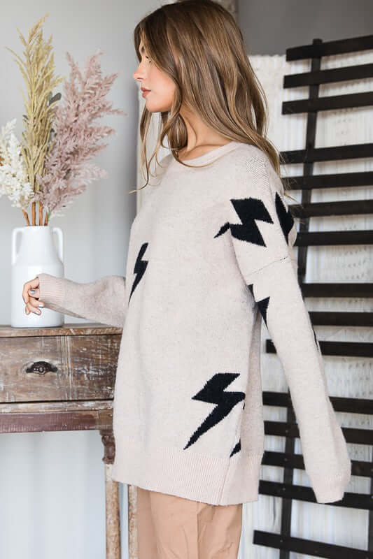 BOLT LONG SLEEVE CREW NECK SWEATER with bolt lightning print in soft fabric, model wearing size small.