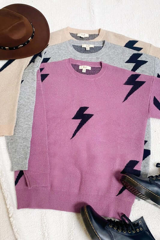 BOLT LONG SLEEVE CREW NECK SWEATER in pink, gray, and beige with lightning bolt print, displayed with hat and shoes.