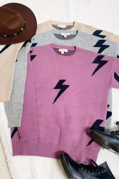 BOLT LONG SLEEVE CREW NECK SWEATER in pink, gray, and beige with lightning bolt print, displayed with hat and shoes.