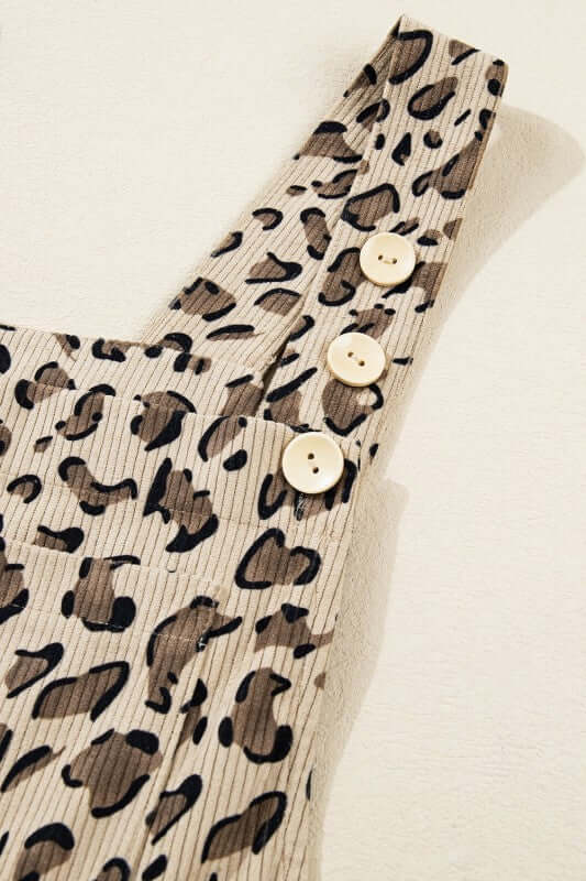 Leopard Bib Wide Leg Jumpsuit close-up showing chic bib detail and buttons on shoulder strap.
