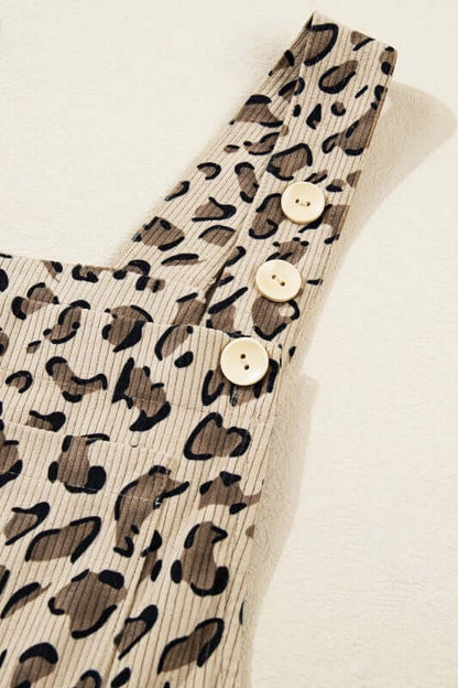 Leopard Bib Wide Leg Jumpsuit close-up showing chic bib detail and buttons on shoulder strap.