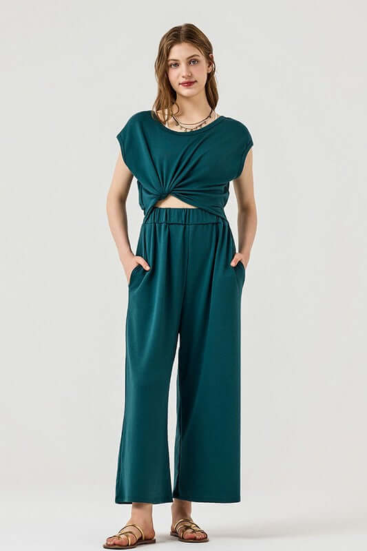Model wearing Open Front Wide Leg Jumpsuit featuring a trendy twist-front design and side pockets.