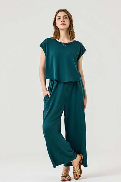 Open Front Wide Leg Jumpsuit in teal, featuring relaxed wide-leg fit and twist-front design with pockets.