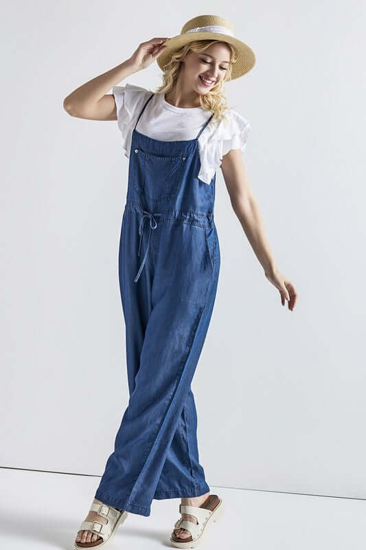 Plus Pocket Adjustable Straps Overall Jumpsuit modeled by a woman in denim jumpsuit with a white top and hat.