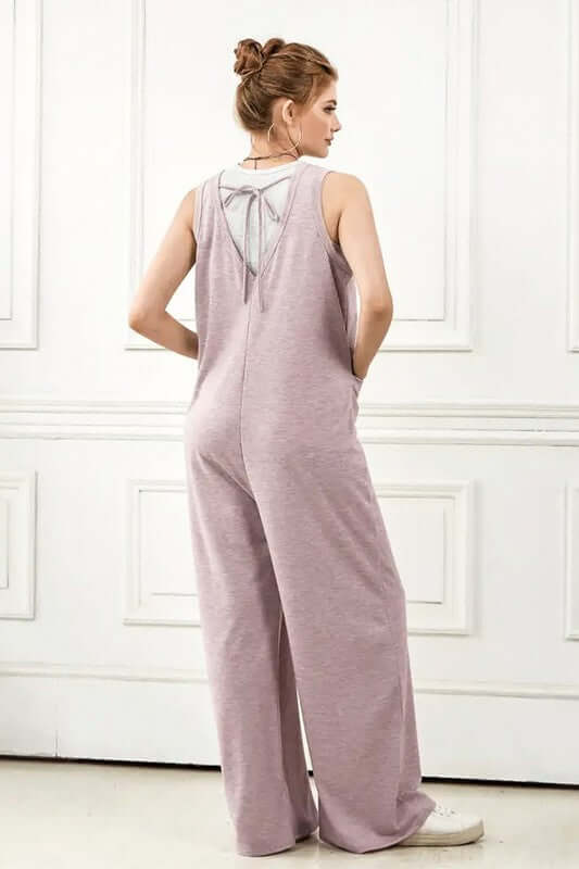 Back view of an Oversized Patched Pocket V-Neck Jumpsuit showing drawstring detail and wide-leg fit.