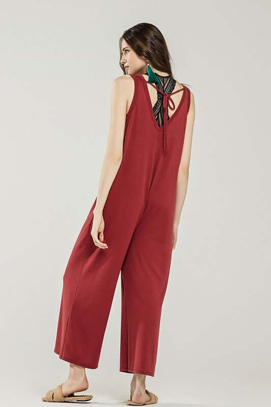 Model wearing an Oversized Patched Pocket V-Neck Jumpsuit in red with back drawstring detail.