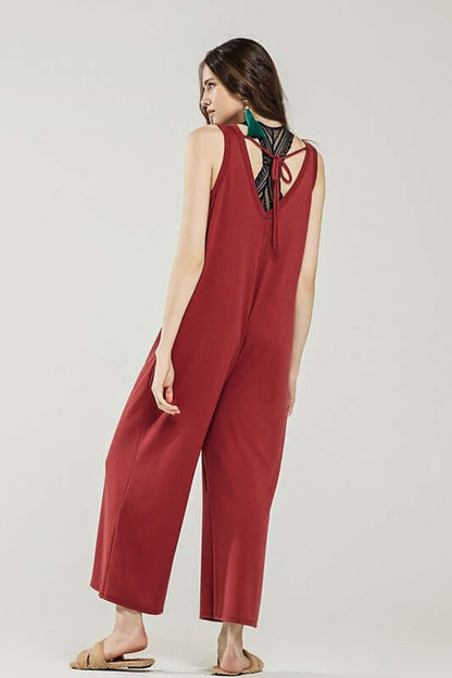 Model wearing an Oversized Patched Pocket V-Neck Jumpsuit in red with back drawstring detail.