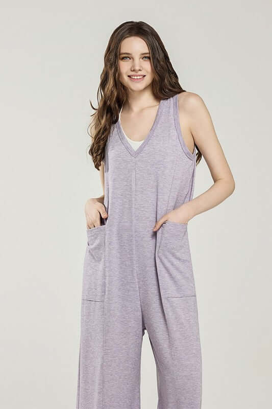 Model wearing an Oversized Patched Pocket V-Neck Jumpsuit in light purple color with front pockets.