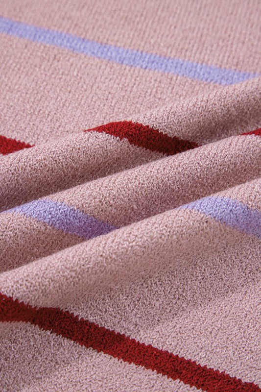 Close-up of fabric texture from Stripe Ribbed Trim Drop Shoulder Sweater with red and blue stripes on a beige background.