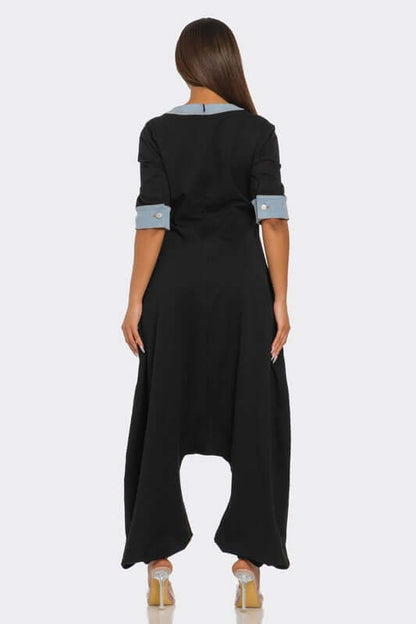 Back view of the Denim Accent Jumpsuit featuring oversized pockets and elbow-length sleeves with denim trim.
