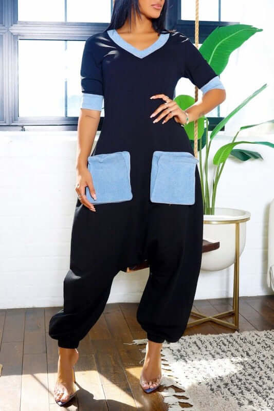 Denim Accent Jumpsuit featuring a V-neckline, elbow-length sleeves, and oversized denim patch pockets for a stylish look.