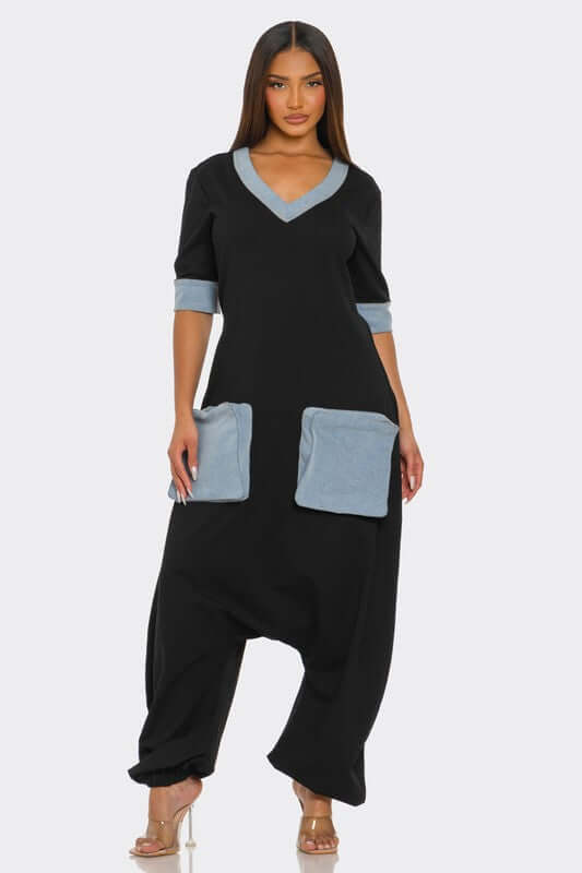 Denim Accent Jumpsuit featuring a V-neckline, denim trimmed sleeves, and oversized pockets for a stylish and comfortable fit.