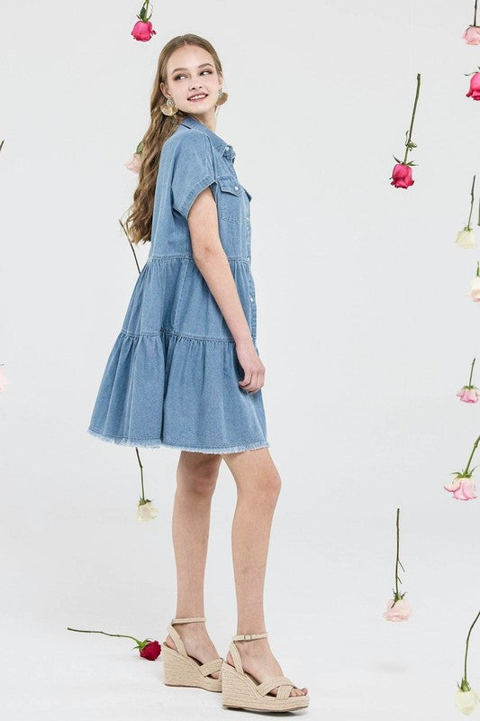 Button Down Tiered Babydoll Denim Shirt Dress showcased from the side with floral background.