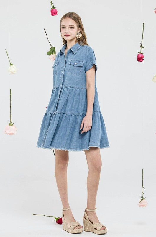 Model wearing a Button Down Tiered Babydoll Denim Shirt Dress, showcasing its flattering A-line design and chic collar.