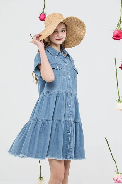 Button Down Tiered Babydoll Denim Shirt Dress worn by a model with a straw hat, showcasing its stylish design and A-line silhouette.
