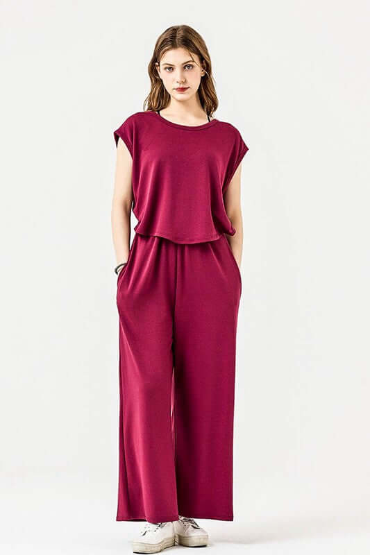 Model showcasing an Open Front Wide Leg Jumpsuit in a rich burgundy color with side pockets and relaxed fit.
