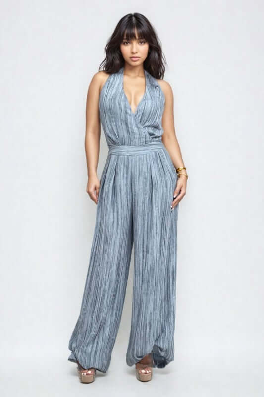 Skyline Halter Jumpsuit in serene blue with wide-leg trousers and deep V-neckline for a sophisticated evening look.
