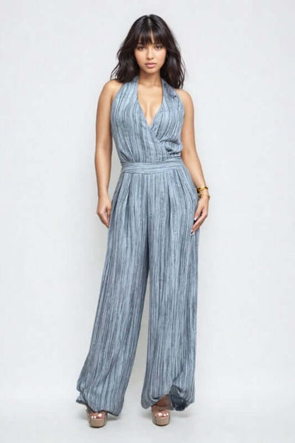 Skyline Halter Jumpsuit in serene blue with wide-leg trousers and deep V-neckline for a sophisticated evening look.