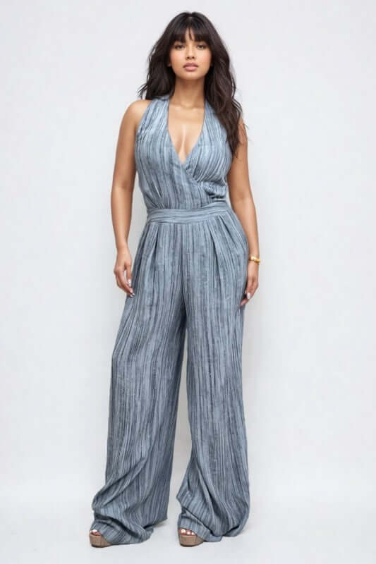 Skyline Halter Jumpsuit featuring a deep V-neckline and wide-leg trousers in a serene blue hue.