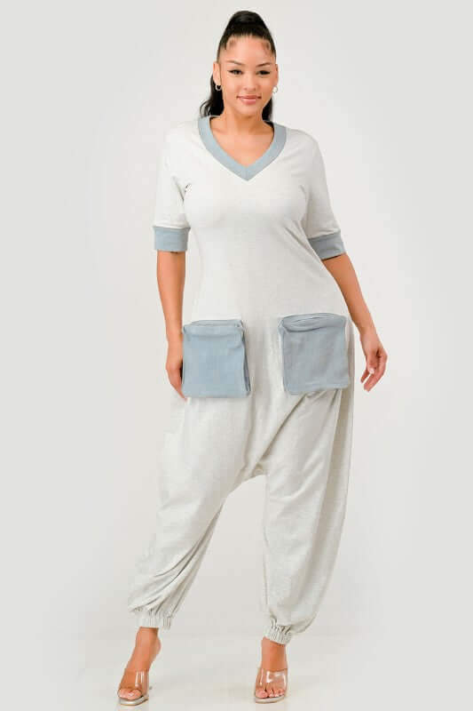 Denim Accent Jumpsuit showcasing a relaxed fit with V-neckline and oversized denim pockets for utility-inspired style.