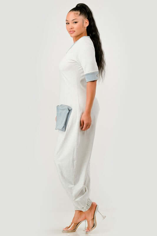 Denim Accent Jumpsuit featuring relaxed fit, V-neckline, and oversized denim patch pockets for utility and style.