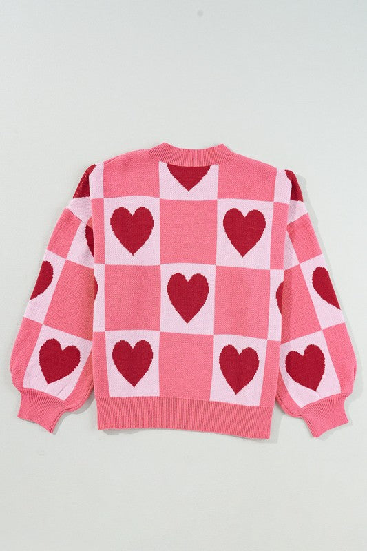 Love Heart Checkered Valentine Crew Neck Sweater with pink and red heart pattern, bubble sleeves, and crew neck; perfect for Valentine's Day.