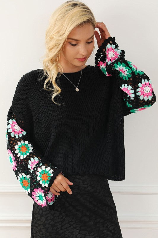 Black Floral Crochet Bell Sleeve Loose Sweater with colorful crochet sleeves and boat neckline, featuring a relaxed fit, 100% Acrylic.