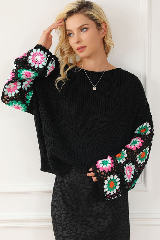 Black Floral Crochet Bell Sleeve Loose Sweater with floral crochet sleeves and relaxed fit, featuring a ribbed design and boat neckline.
