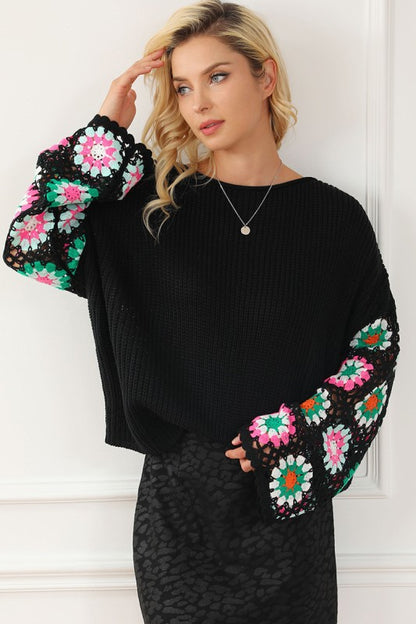 Black Floral Crochet Bell Sleeve Loose Sweater with floral crochet sleeves and relaxed fit, featuring a ribbed design and boat neckline.