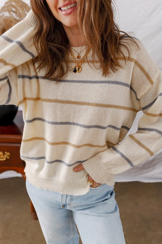 Woman wearing a Stripe Ribbed Trim Drop Shoulder Sweater with chic striped design and cozy fit, perfect for fall fashion.