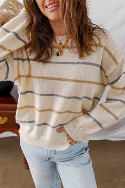 Woman wearing a Stripe Ribbed Trim Drop Shoulder Sweater with chic striped design and cozy fit, perfect for fall fashion.