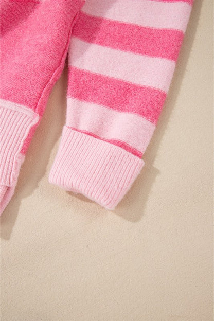 Detail of pink striped sleeve of Abigail High Low Loose Sweater, showcasing classic colorblocking and feminine style.