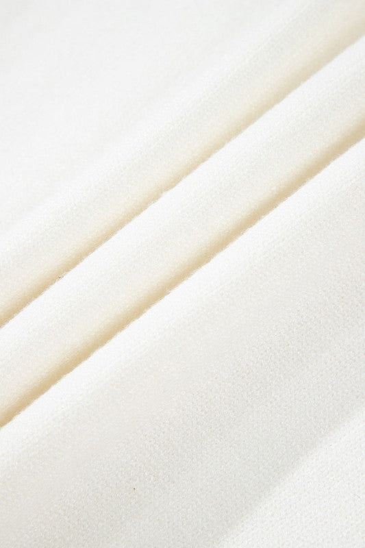 Close-up of cozy knit fabric from Avery Print Drop Shoulder Sweater showcasing texture and warmth.