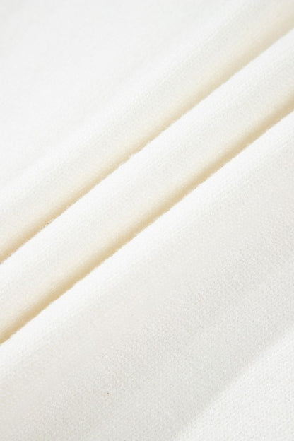 Close-up of cozy knit fabric from Avery Print Drop Shoulder Sweater showcasing texture and warmth.