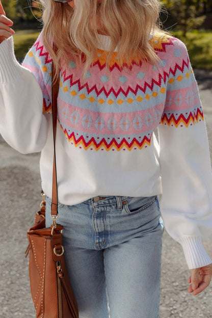 Woman wearing Avery Print Drop Shoulder Sweater with geometric pattern and colorblock design, paired with jeans outdoors.