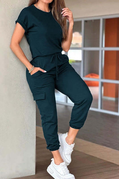 Model wearing a Crew Neck Short Sleeve Drawstring Waist Jumpsuit in dark color, perfect for casual outdoor occasions.