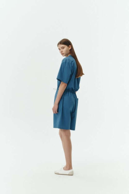 Emma Solid Jumpsuit in a soft blue color, showcasing a relaxed fit and breathable 100% cotton material.