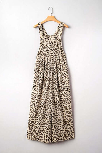 Leopard Bib Wide Leg Jumpsuit hanging on a wooden hanger, featuring a trendy leopard print design.