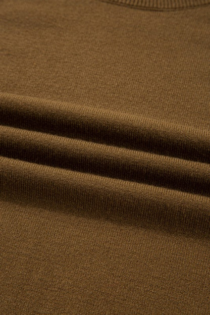 Close-up texture of Colorblock Raglan Puff Sleeve Mock Neck Sweater in brown fabric.