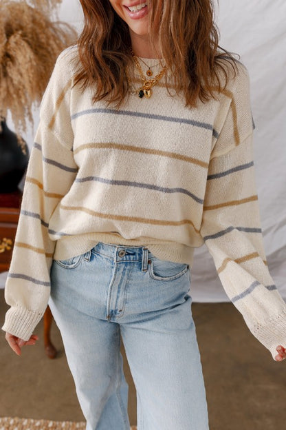 Woman wearing a Stripe Ribbed Trim Drop Shoulder Sweater with jeans in a casual setting